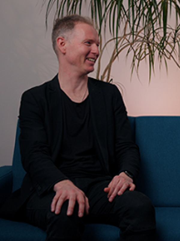 Prof Paul Hodkinson chatting on a sofa